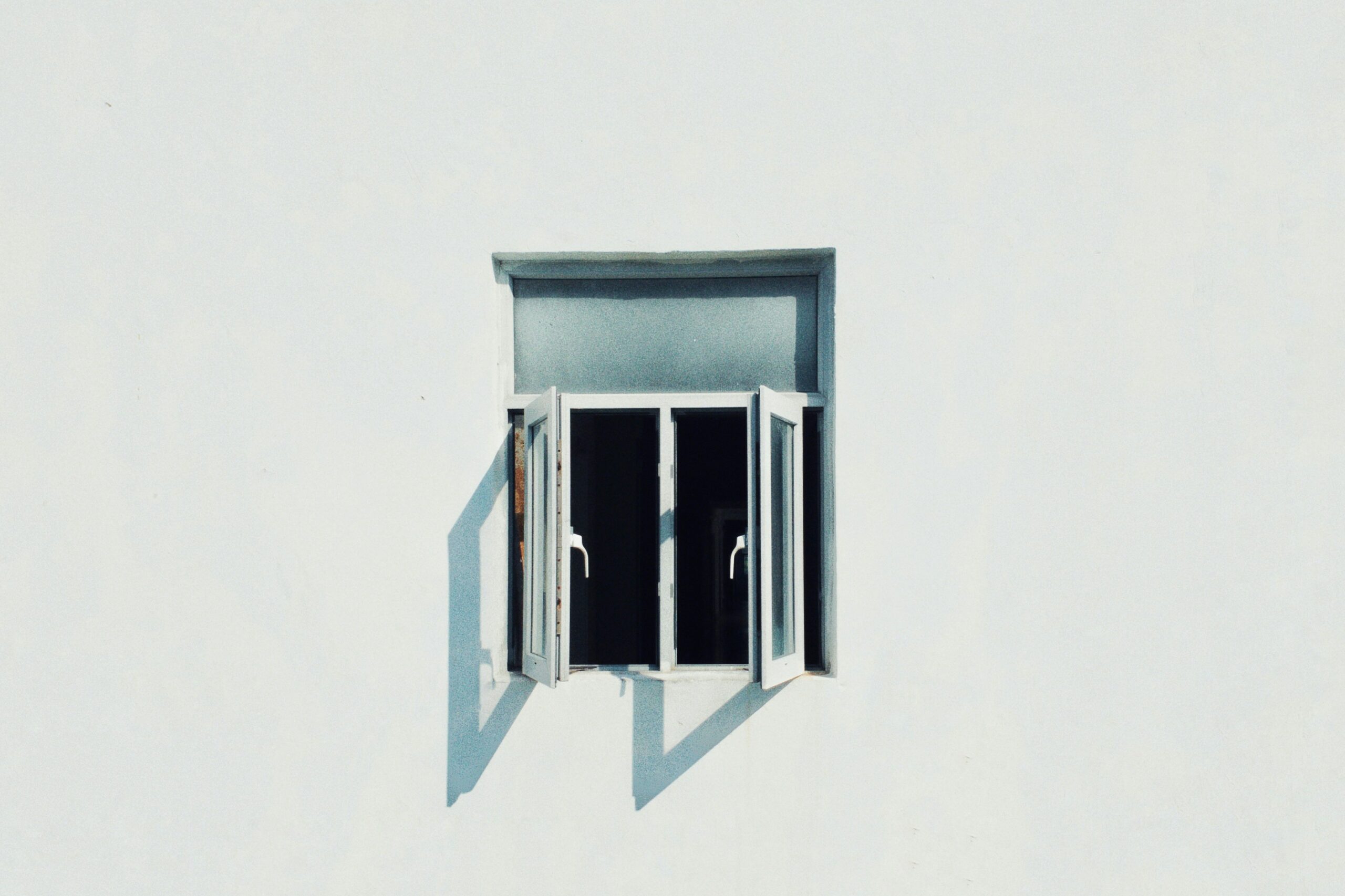 An open window on a white building
