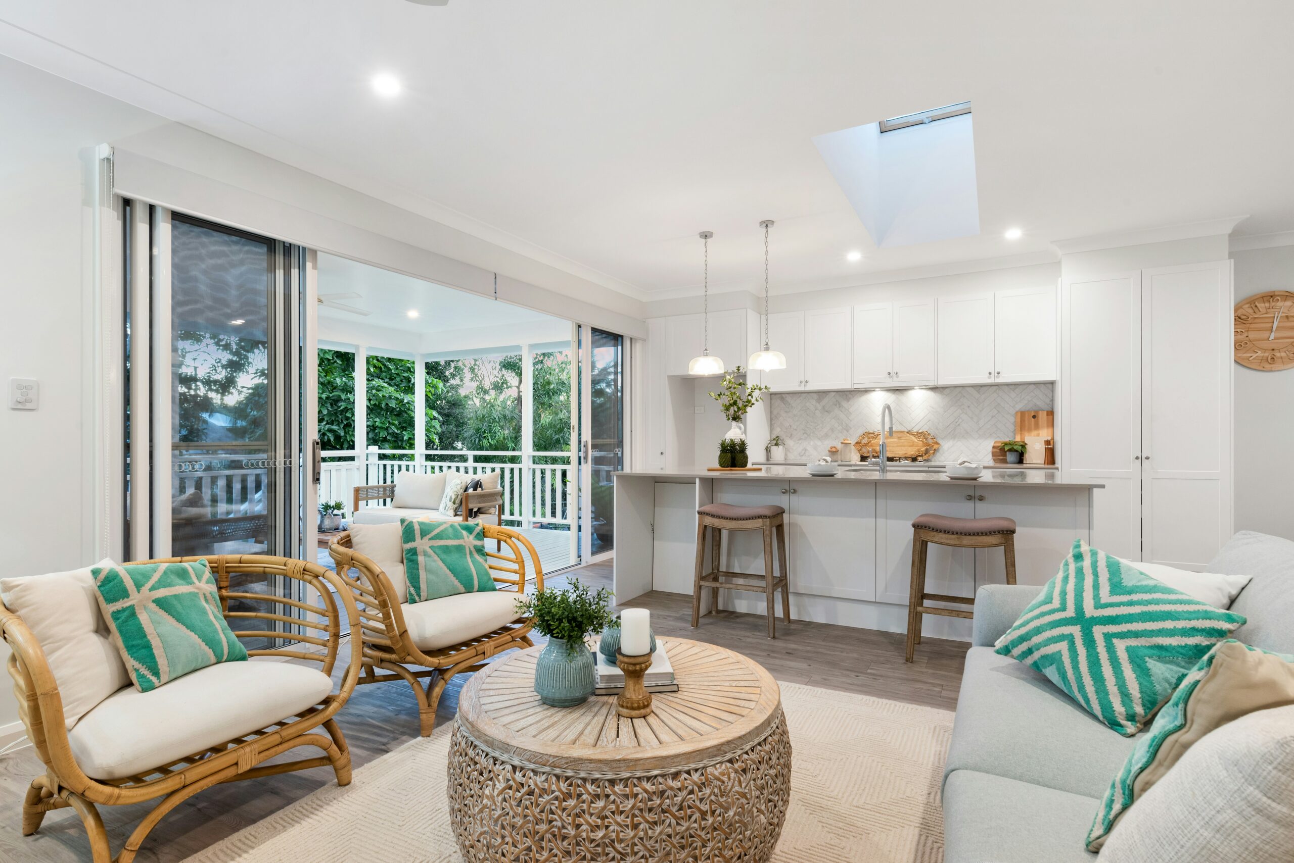 brightly lit living room/kitchen with open sliding patio doors