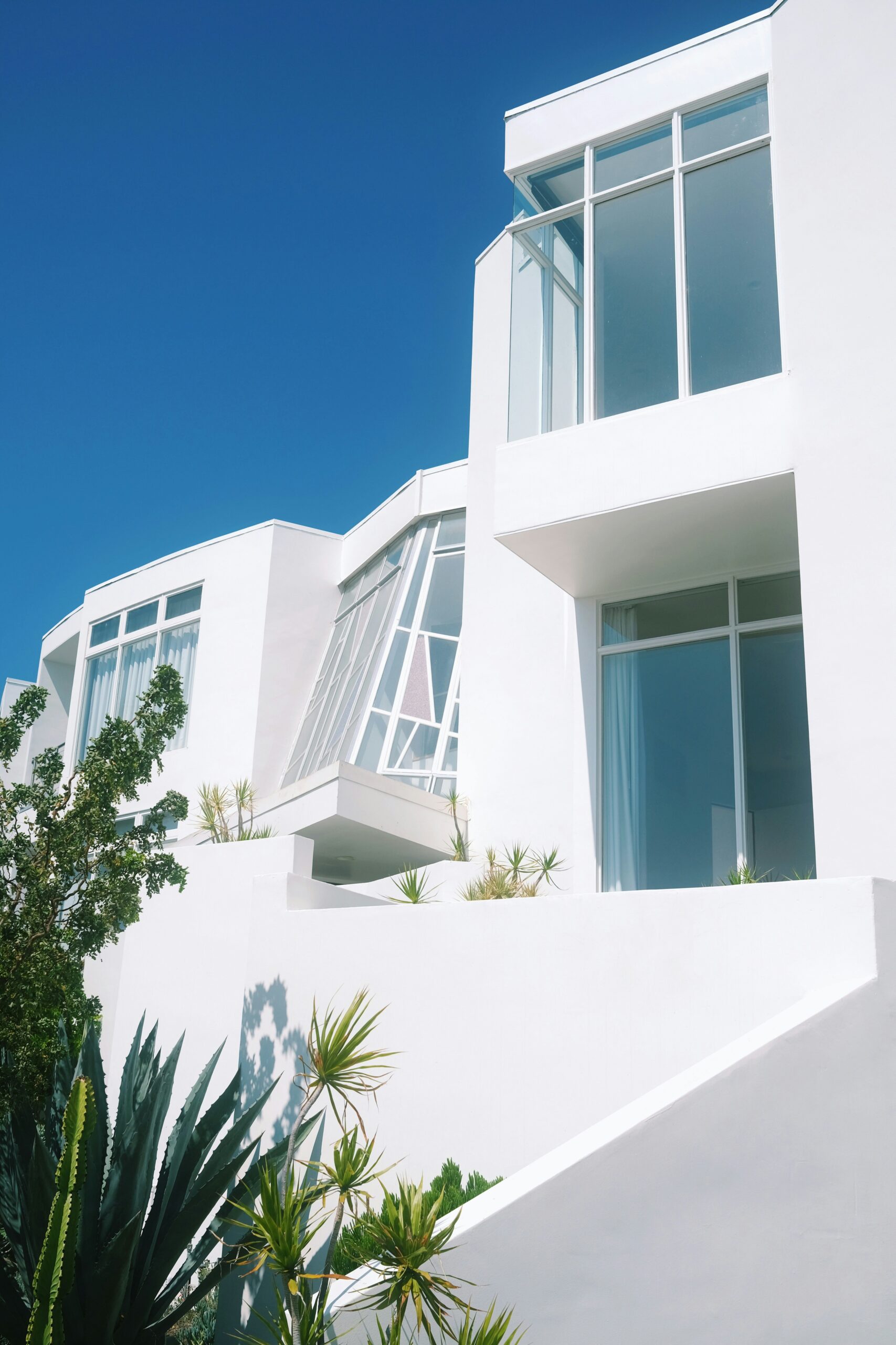 A tall white building with lots of windows